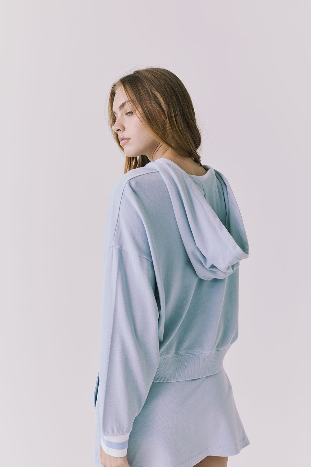 Chaser Abilene Blue Bird Zip Up from a three quarter back angle showing the draped hood and slouchy silhouette