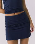 Chaser Rue Navy Skort in Navy highlighting the ruched waistband and smooth stretch fabrication