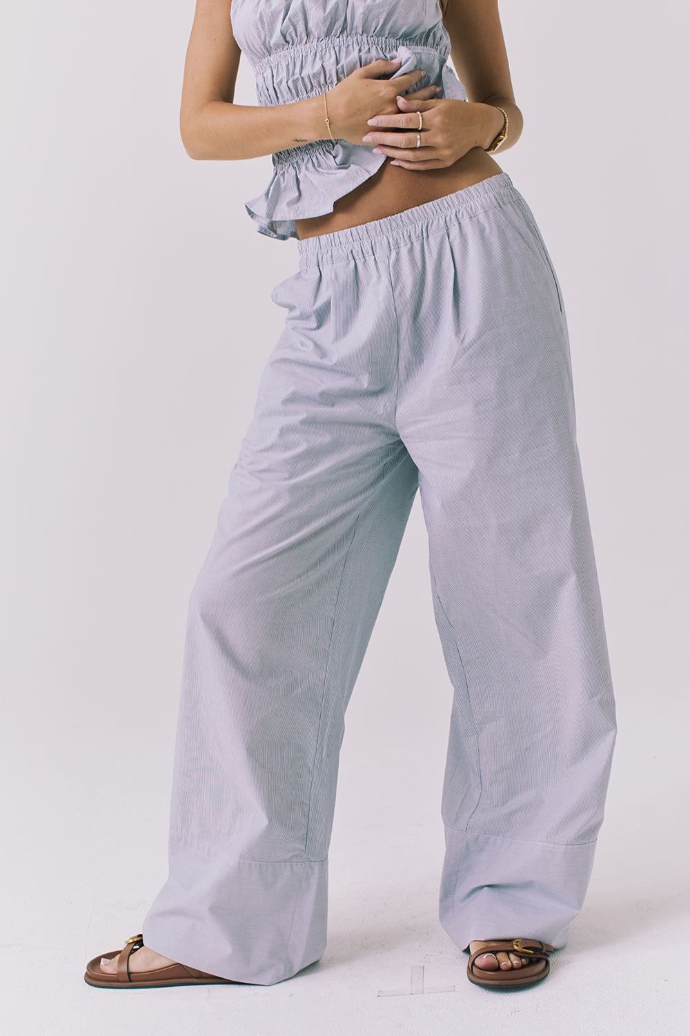 Chaser Dorit Pinstripe Trousers in soft blue pinstripe shown from the front with a relaxed elastic waistband and wide leg drape that moves easily through the hip and thigh