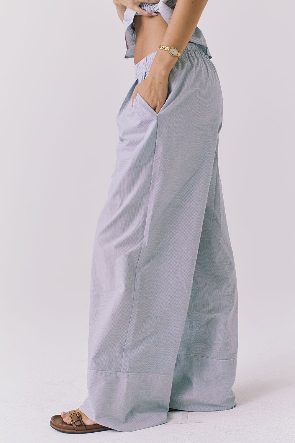 Side view of the Chaser Dorit Pinstripe Trousers highlighting the fluid silhouette pocket placement and lightweight fabric with subtle texture