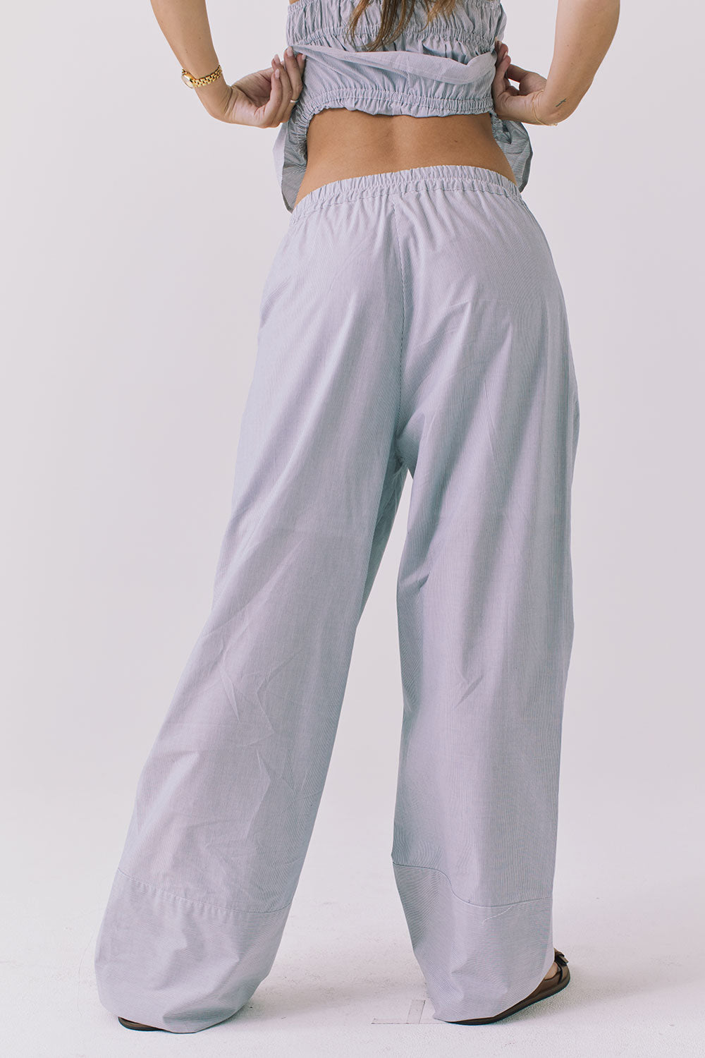 Back view of the Chaser Dorit Pinstripe Trousers showing the easy pull on fit elastic waistband and clean wide leg finish
