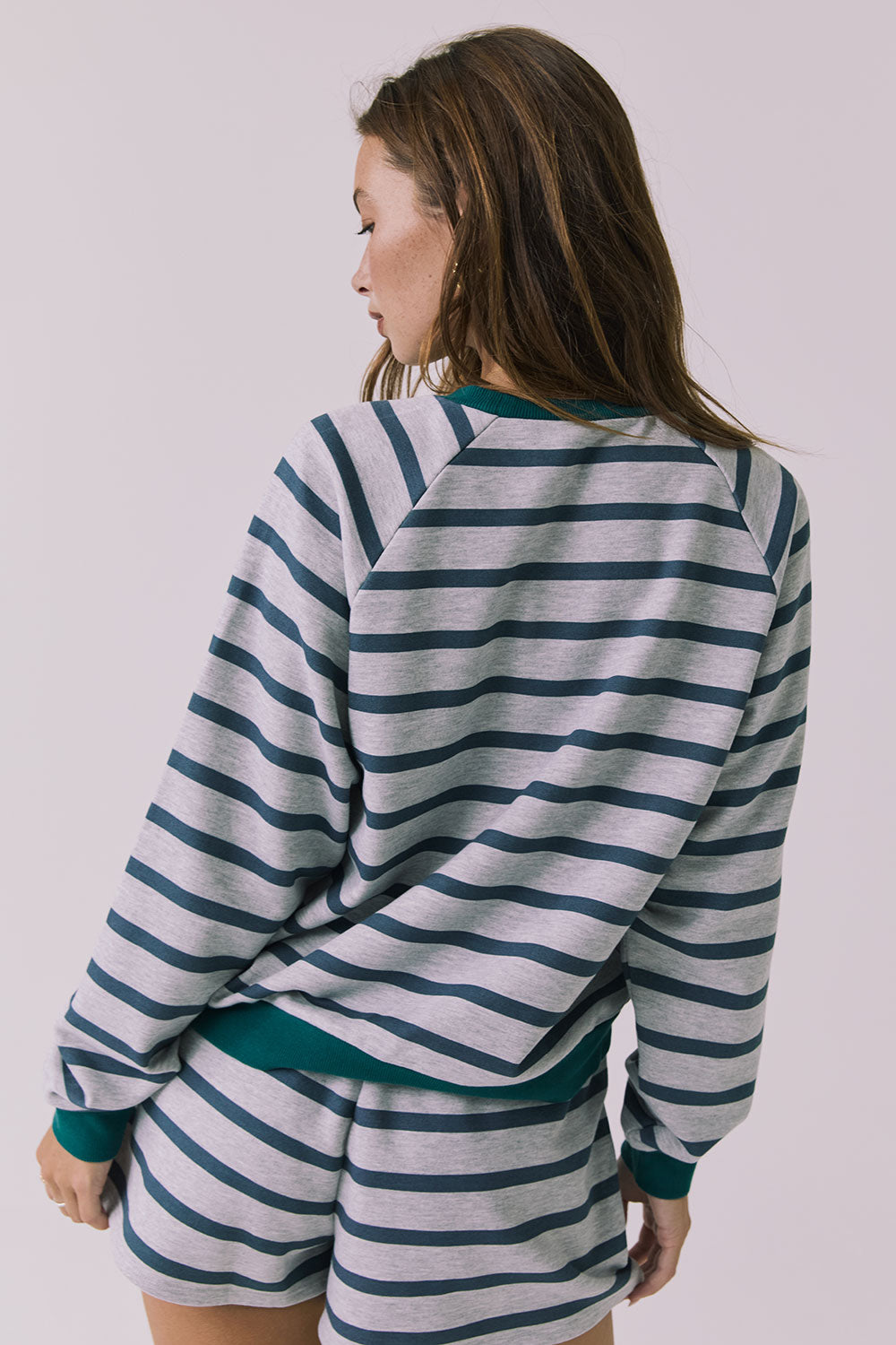 Back view of the Chaser Resort Stripe Long Sleeve Top in Heather Grey showing the striped back and ribbed hem