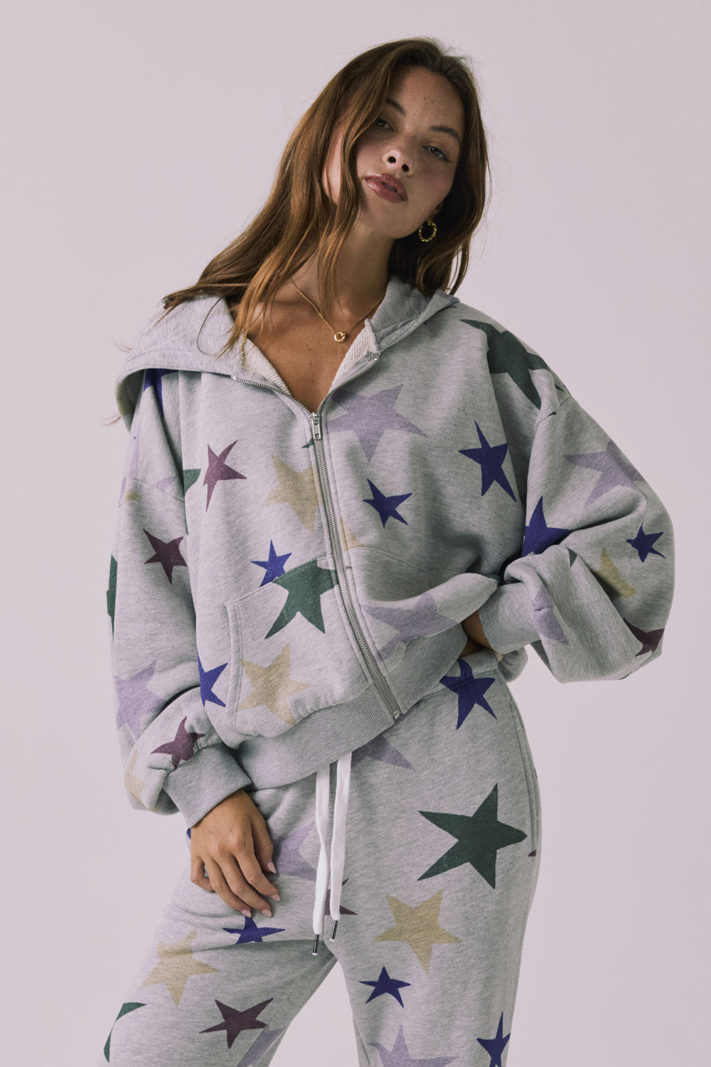 Chaser You’re A Star Zip Up Hoodie in Heather Grey featuring an allover star print zip front and relaxed cropped fit