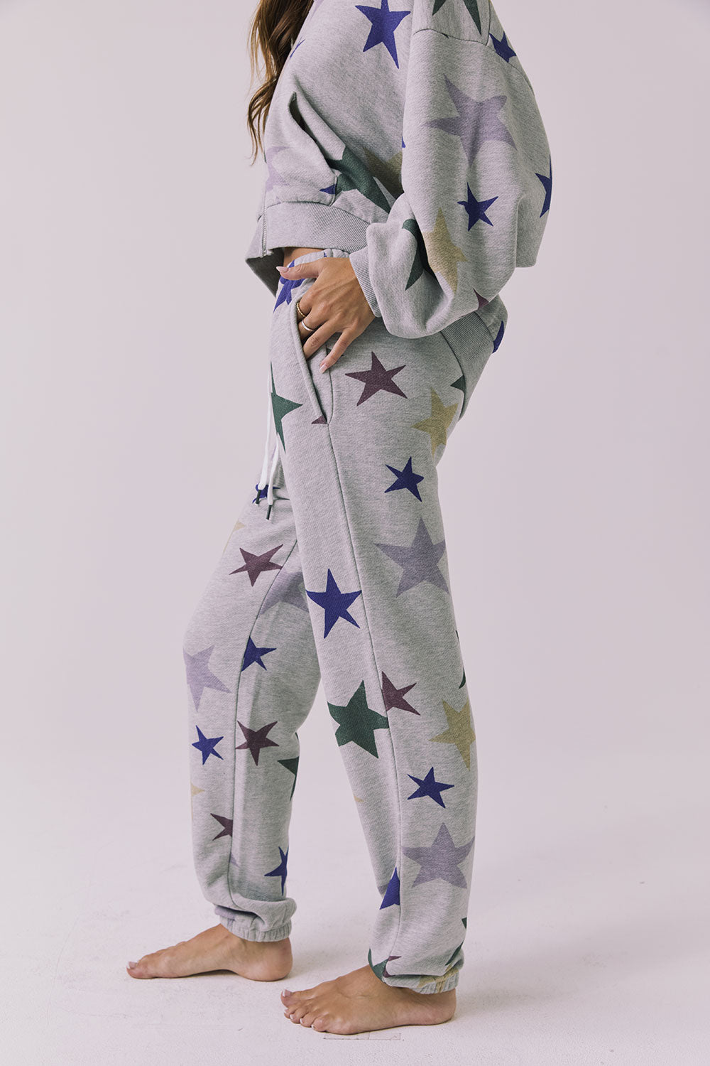 Side view of the Chaser You’re A Star Pants in Heather Grey highlighting the easy drape pocket placement and cuffed hem