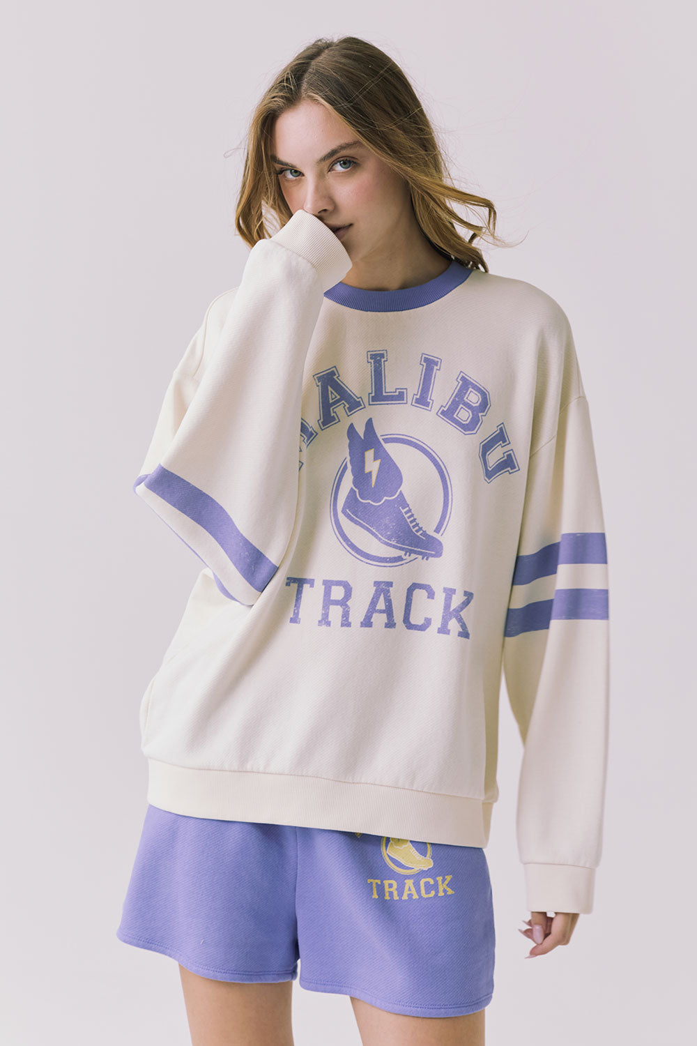 Chaser Malibu Track Long Sleeve Starry White with Soft Blue stripe detail styled with coordinating athletic shorts