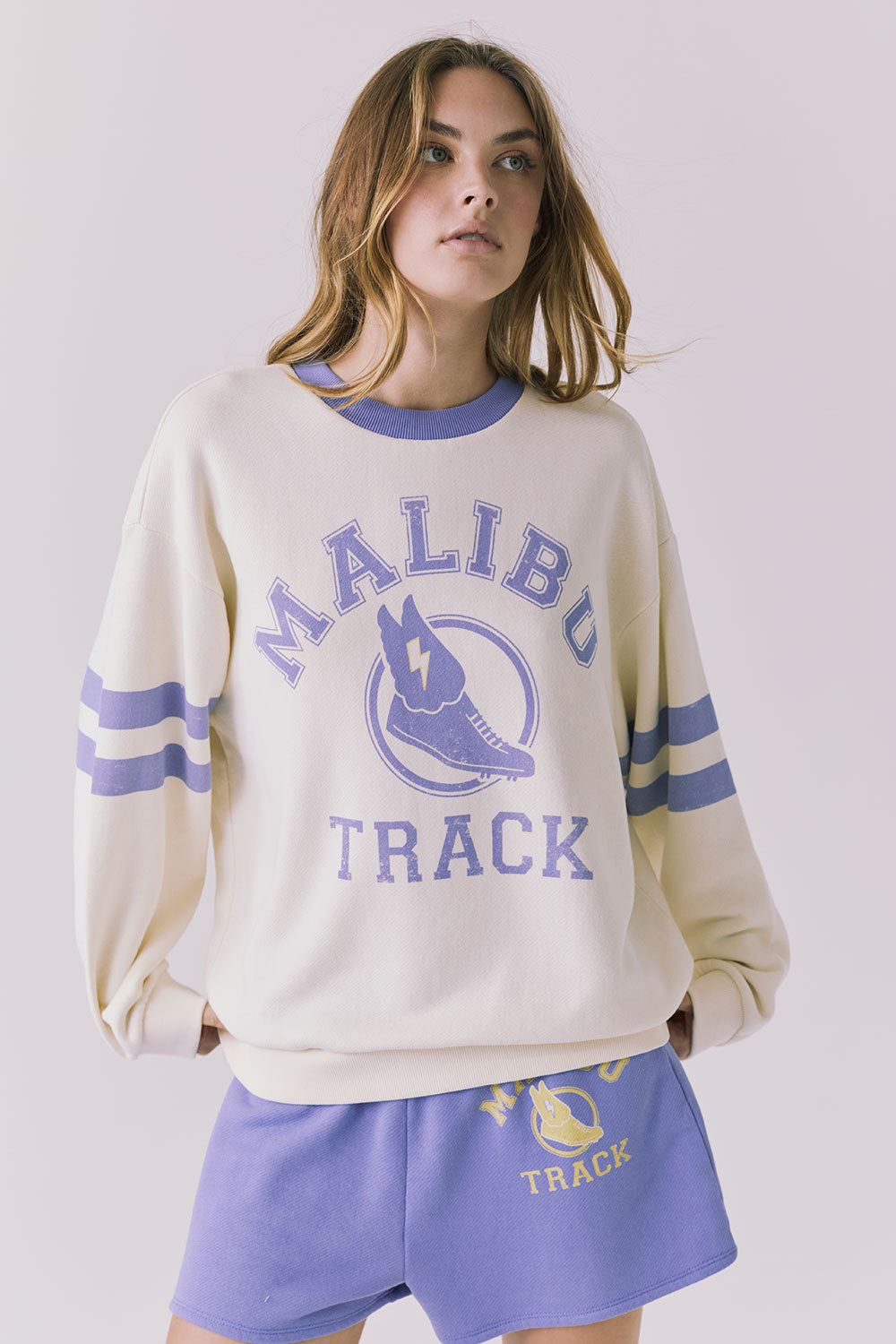 Chaser Malibu Track Long Sleeve in Starry White and Soft Blue with vintage Malibu Track graphic and varsity sleeve stripes in soft blue