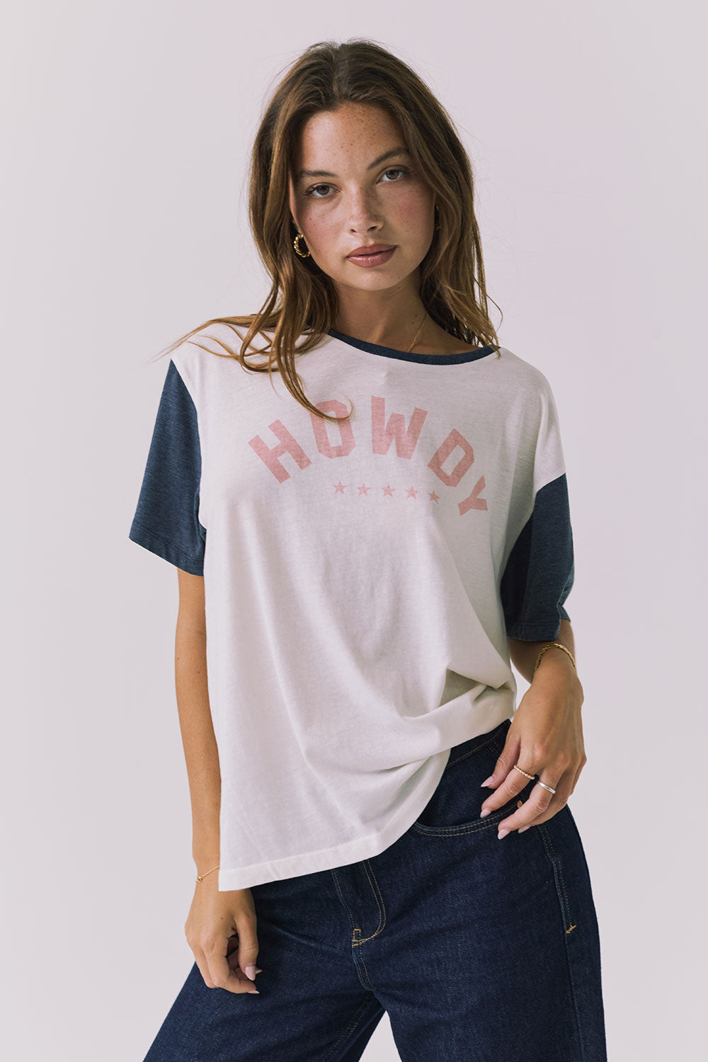 Chaser Howdy Tee in Starry White and Navy shown from the front featuring a soft pink collegiate Howdy graphic across the chest and contrast navy sleeves