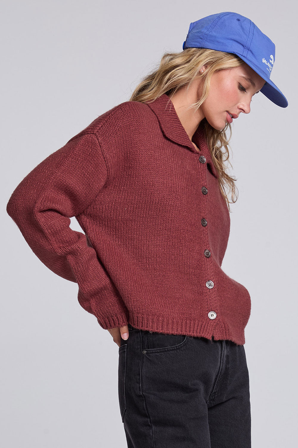 Model wearing Chaser's Hot Cocoa Fortune Cardigan in Hot Cocoa brown cropped button-front knit with pointed collar, angled view