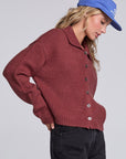 Model wearing Chaser's Hot Cocoa Fortune Cardigan in Hot Cocoa brown cropped button-front knit with pointed collar, angled view