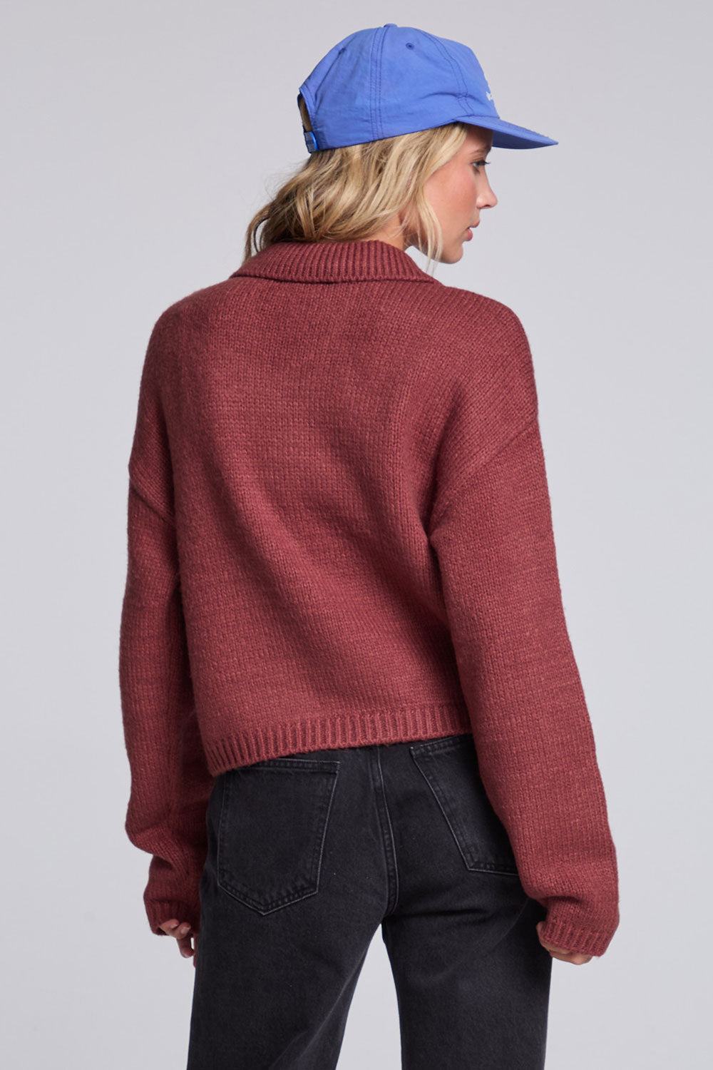 Model wearing Chaser's Hot Cocoa Fortune Cardigan in Hot Cocoa brown cropped button-front knit with pointed collar, back view