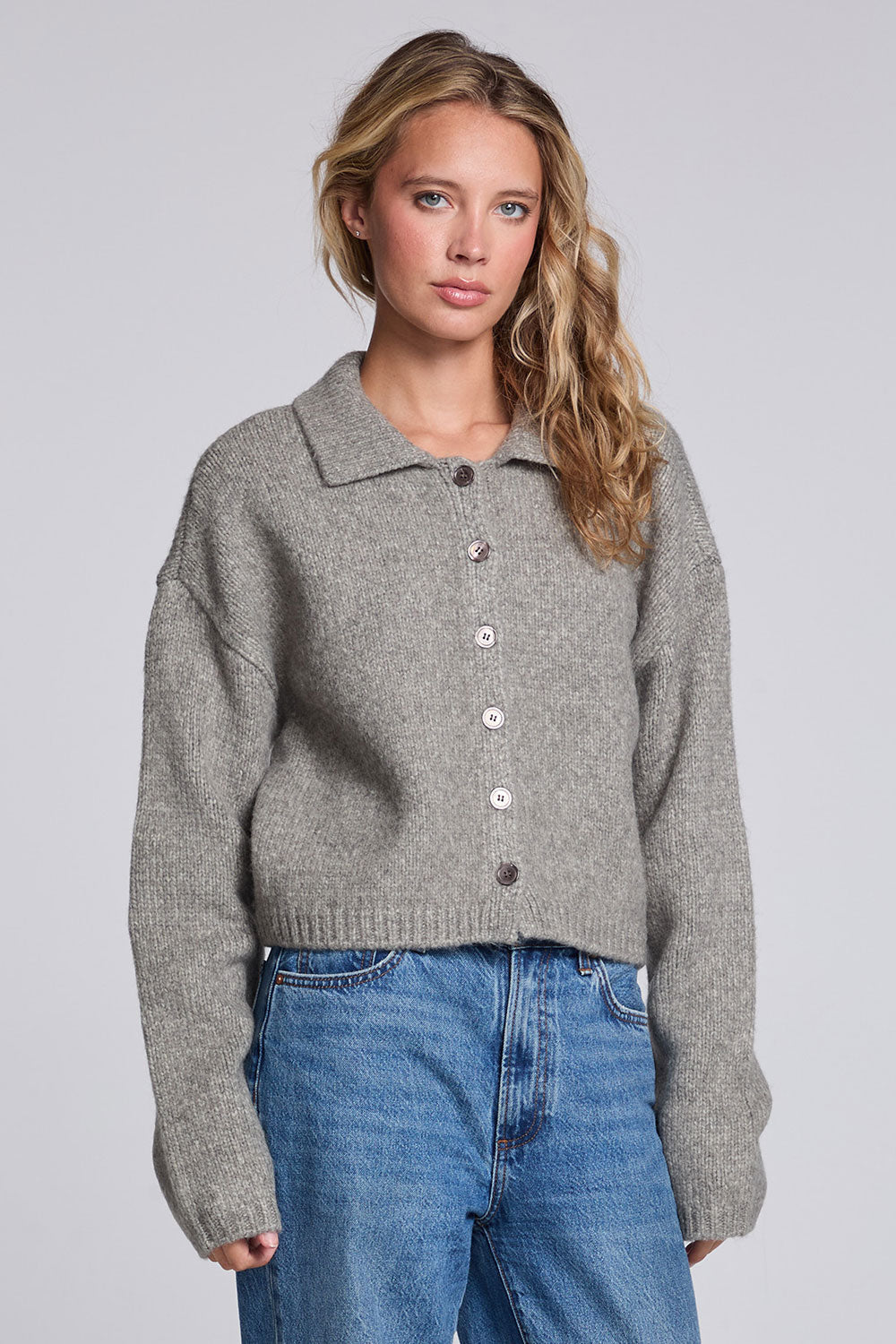 Model wearing Chaser's Winter Heather Grey Fortune Cardigan in Winter Heather Grey cropped button-front knit with pointed collar, angled view
