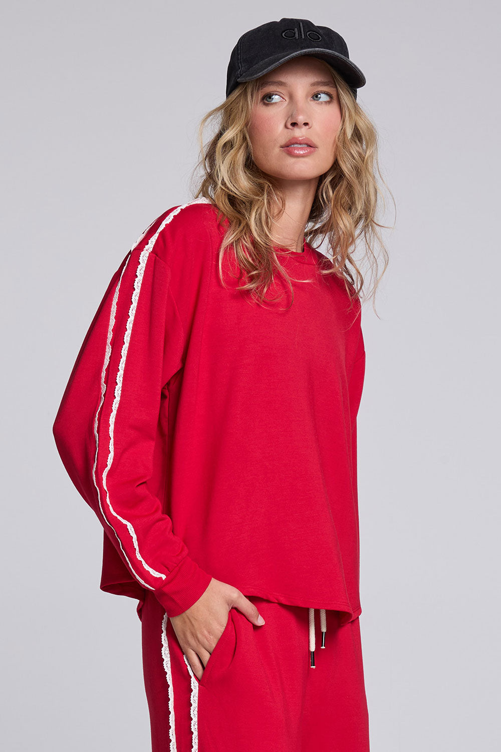 Model wearing Chaser's Cherry Bomb Anastasia Long Sleeve with contrast sleeve stripes, angled view