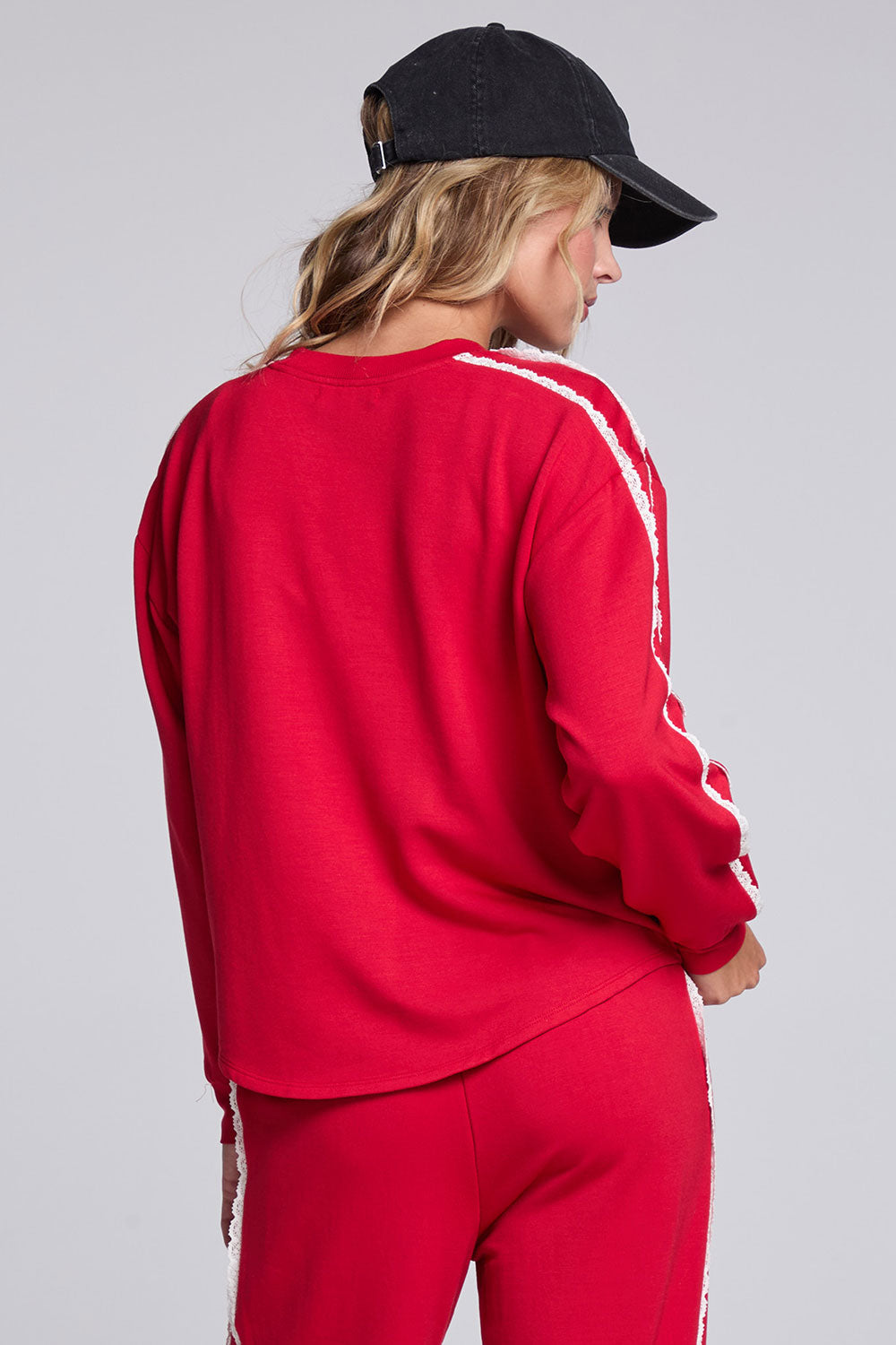 Model wearing Chaser's Cherry Bomb Anastasia Long Sleeve with contrast sleeve stripes, back view