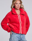 Model wearing Chaser's Cherry Zip-Up in Cherry Bomb red plush zip-up jacket with high collar, angled view