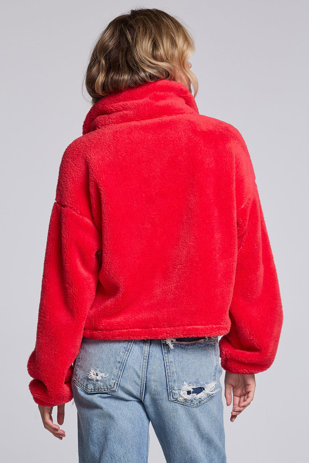 Model wearing Chaser's Cherry Zip-Up in Cherry Bomb red plush zip-up jacket with high collar, back view