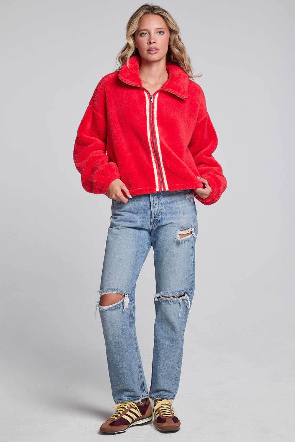 Model wearing Chaser's Cherry Zip-Up in Cherry Bomb red plush zip-up jacket with high collar, full-body view