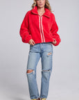 Model wearing Chaser's Cherry Zip-Up in Cherry Bomb red plush zip-up jacket with high collar, full-body view