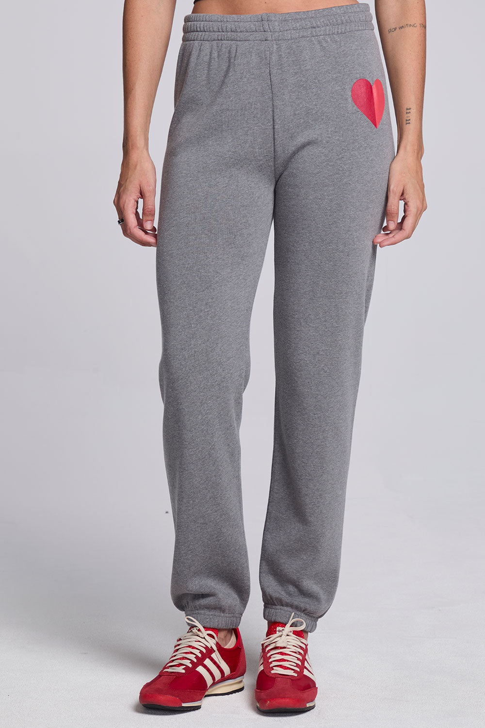 Model wearing Chaser's Dual Tone Heart Jogger in Streaky with a single red heart, front view