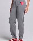 Model wearing Chaser's Dual Tone Heart Jogger in Streaky with a single red heart, angled view