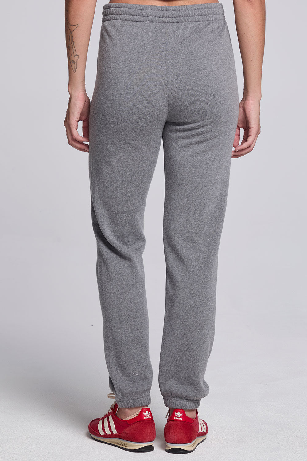 Model wearing Chaser's Dual Tone Heart Jogger in Streaky with a single red heart, back view