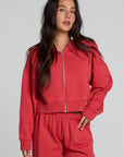 Front view of a woman wearing the Chaser  Abilene Dry Red Zip Upon a neutral background