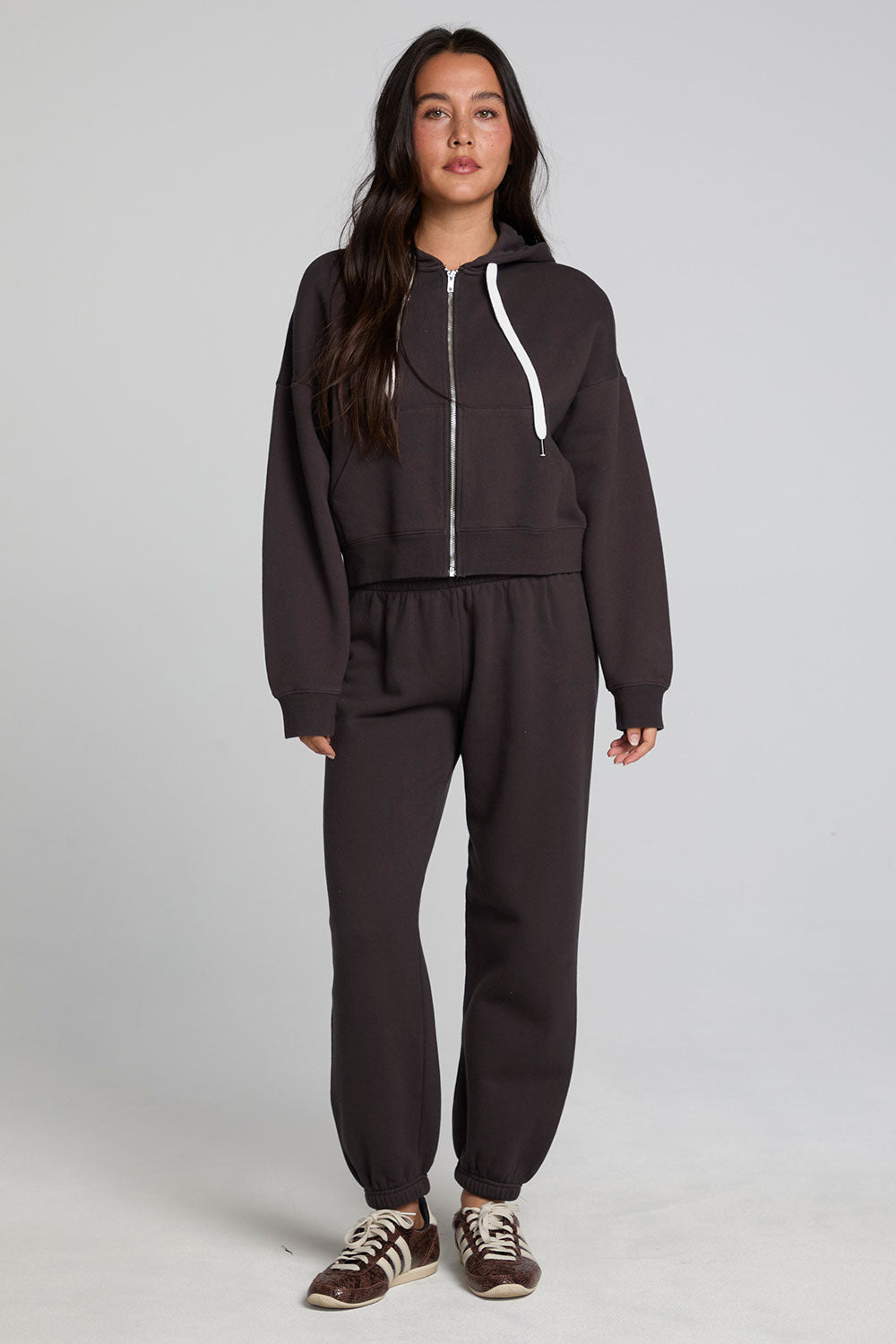 A full body front view of a woman wearing the Chaser Ada Dark Heather Grey Jogger on a neutral background