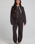 A full body front view of a woman wearing the Chaser Ada Dark Heather Grey Jogger on a neutral background