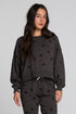 Back view of a woman wearing the Chaser Chaser Allover Mini Stars Long Sleeve and matching pants on a neutral background with arms lowered