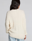 Back view of a woman wearing the Chaser Antique White Harpur Pullover on a neutral background with jeans