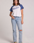 A full body front view of a woman wearing the Chaser Athletics Club Tee on a neutral background