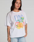 Front view of a woman wearing the Chaser Bagged Italy Tee on a neutral background with blue jeans
