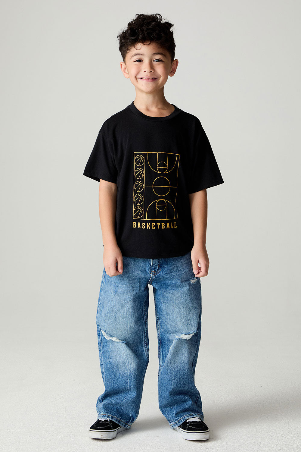 A full body front view of a boy wearing the Chaser  Basketball Boys Tee on a neutral background