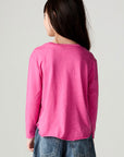Back view of a girl wearing the Chaser Best Sister Girls Tee on a neutral background and jeans