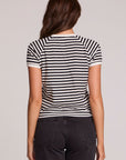 Back view of a woman wearing the Chaser Bisous Tee on a neutral background with pants 