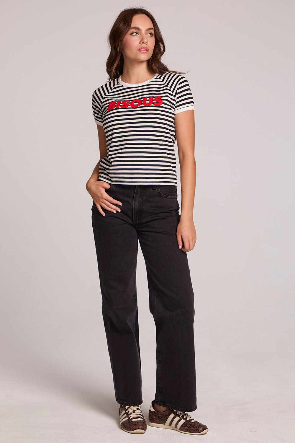 A full body front view of a woman wearing the Chaser Bisous Tee on a neutral background