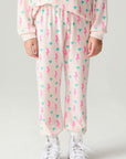 Front view of a girl wearing the Chaser Bolt Hearts Girls Jogger on a neutral background with matching long sleeve top