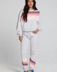 Full body front view of a woman wearing the Chaser Cashbah Heather Grey Pullover and grey matching pants on a neutral background