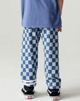 Back view of a boy wearing the Chaser  Checkered Pants Boys Jogger on a neutral background with shirt
