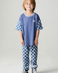 A full body front view of a boy wearing the Chaser Smileys Boys Tee on a neutral background