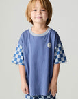 Front view of a boy wearing the Chaser Smileys Boys Tee on a neutral background with matching checkered pants