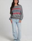 A full body front view of a woman wearing the Chaser Chicago Sweatshirt on a neutral background
