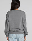 Back view of a woman wearing the Chaser Chicago Sweatshirt on a neutral background with hair over shoulder