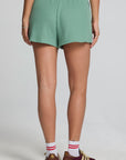Back view of a woman wearing the Chaser Clary Verdelle Relaxed Shorts on a neutral background