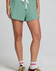 Front view of a woman wearing the Chaser Clary Verdelle Relaxed Shorts on a neutral background with sneakers