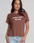 Front view of a woman wearing the Chaser Cute Buttired Top on a neutral background with blue jeans