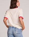 Back view of a woman wearing the Chaser David Bowie Bowie Bolt Tee on a neutral background with jeans
