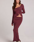 A full body front view of a girl wearing the Chaser Eloyse Brick Red Skirt on a neutral background