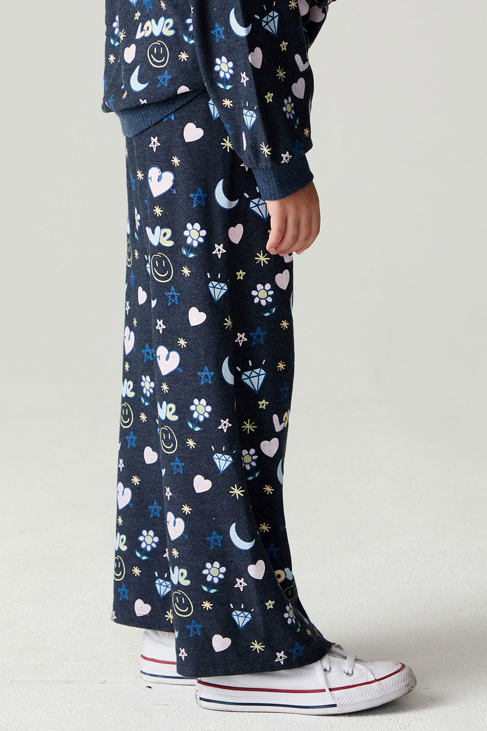 Side view of a girl wearing the Chaser Free Draw Pants Girls Jogger on a neutral background with arms at sides