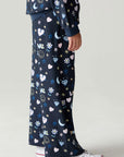 Side view of a girl wearing the Chaser Free Draw Pants Girls Jogger on a neutral background with arms at sides