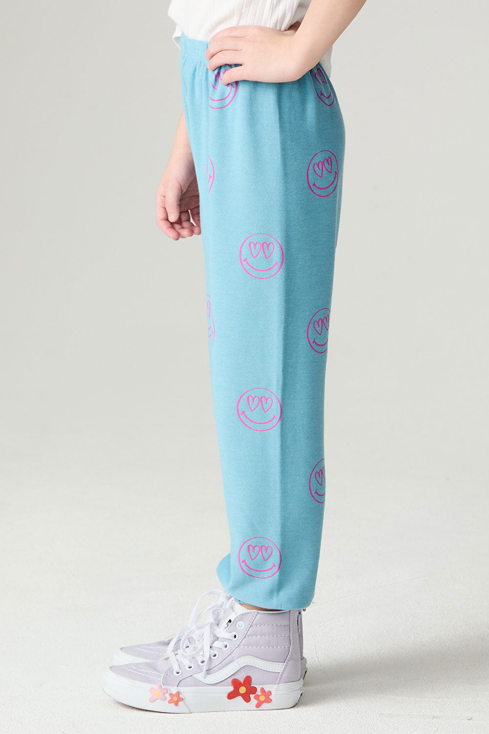 Side view of a girl wearing the Chaser I C Luv Girls Jogger on a neutral background with hand on hip